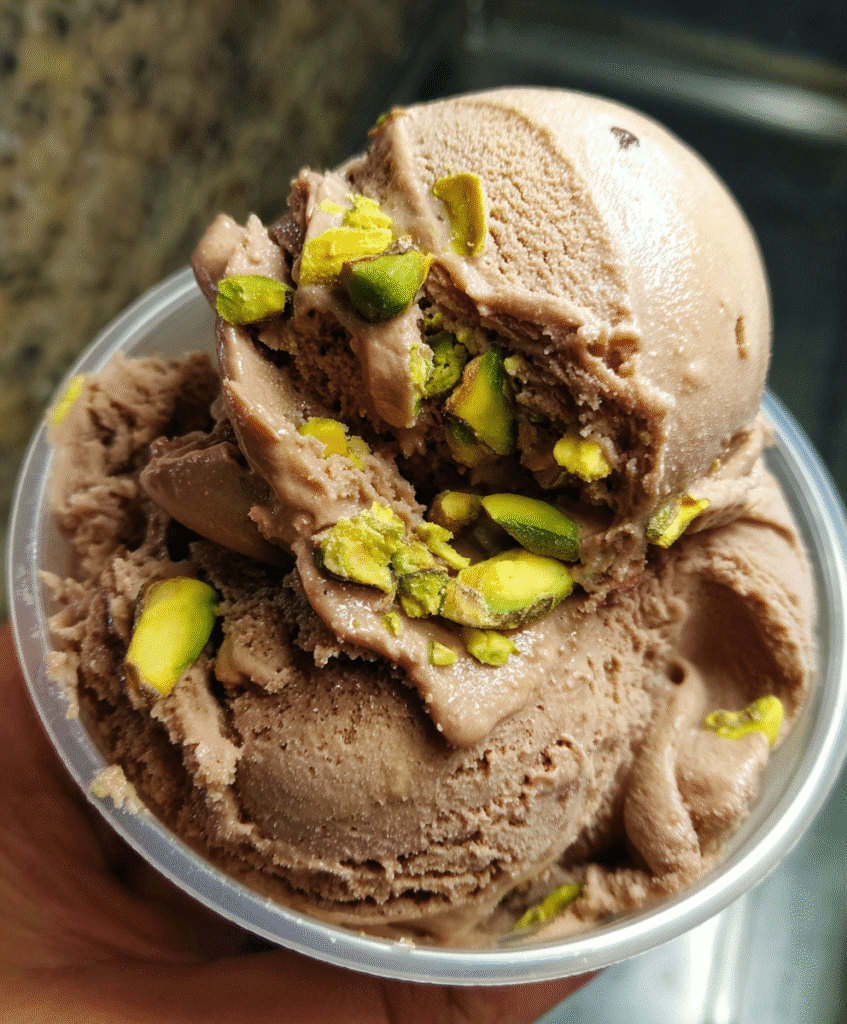 Ingredients for chocolate and pistachio ice cream including heavy cream, milk, cocoa powder, and pistachios.