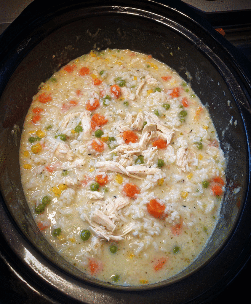 Raw chicken breasts seasoned in slow cooker for crockpot rice and chicken
