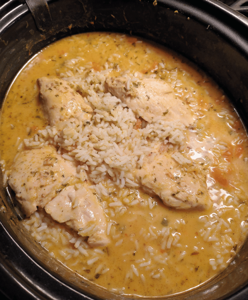 Served crockpot rice and chicken garnished with parsley and green salad
