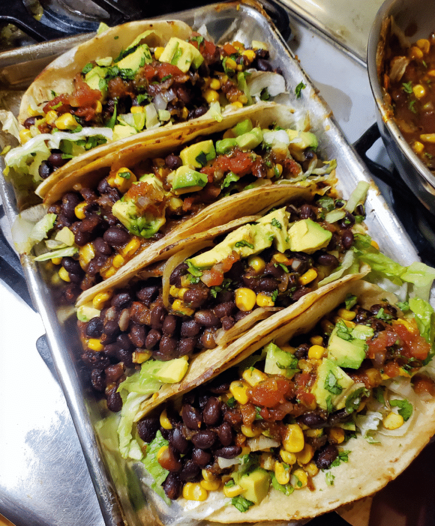 Vegetarian tacos served with lime and side salad