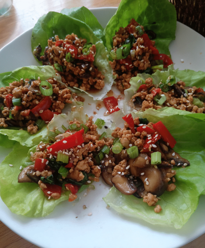 Cooking chicken mixture for Healthy Chicken Lettuce Wraps in a skillet