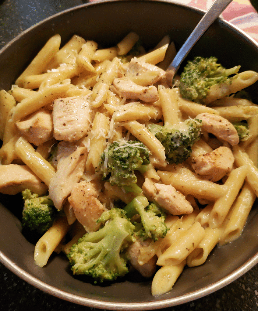 Serving one-pot chicken and broccoli pasta dinner